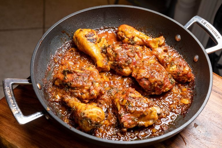 A flavorful Moroccan chicken dish with spices, olives, and vegetables, served in a traditional tagine pot.