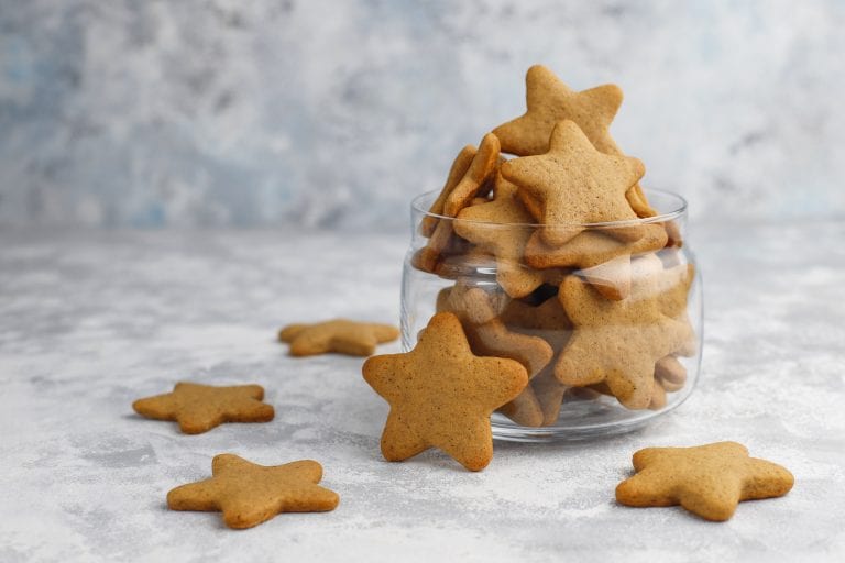A plate of freshly baked gingerbread cookies, decorated with icing and shaped like gingerbread men